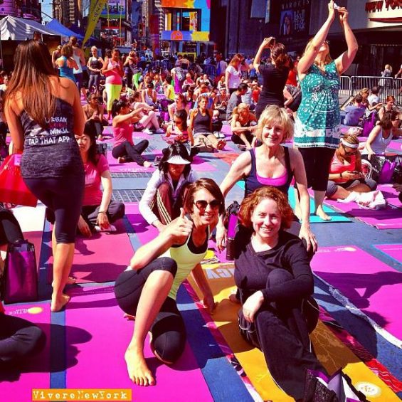 Free yoga class Times Square NYC summer solstice colorful mats Broadway pedestrian plaza