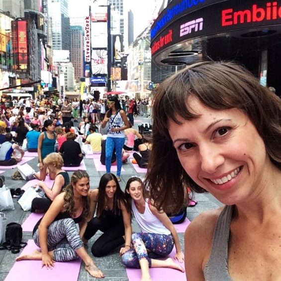 Laura Giromini practicing yoga Times Square NYC Mind Over Madness solstice event